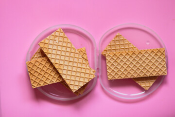 Waffles on a smooth pink background. perfect for illustrating a minimalist breakfast or dessert idea.