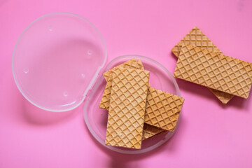 Waffles on a smooth pink background. perfect for illustrating a minimalist breakfast or dessert idea.