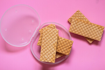 Waffles on a smooth pink background. perfect for illustrating a minimalist breakfast or dessert idea.
