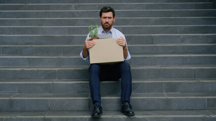 Portrait frustrated sad stressed bankrupt fired work job lost middle-aged Caucasian businessman adult man business guy male in city unemployment crisis holding dismissed box dismissal looking camera