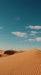Naklejka premium Serene desert landscape under a vibrant blue sky. Golden sand dunes stretch to the horizon.