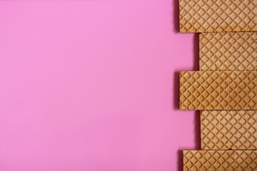 Waffles on a smooth pink background. perfect for illustrating a minimalist breakfast or dessert...