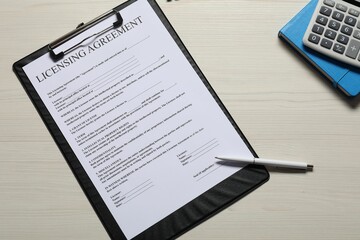 Licensing agreement document, pen, calculator and notebook on white wooden table, flat lay