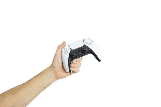 Ovar, Portugal 2025: Man's hand holding White Playstation 5 remote control, arm stretched upwards.
