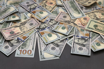 Fototapeta premium Cash hundred dollar banknotes on gray background.