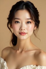 Fototapeta premium Beautiful Asian woman with soft focus in elegant outfit and makeup on a beige background, lipstick, foundation , soft focus