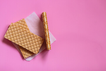 Waffles on a smooth pink background. perfect for illustrating a minimalist breakfast or dessert idea.