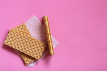 Waffles on a smooth pink background. perfect for illustrating a minimalist breakfast or dessert idea.