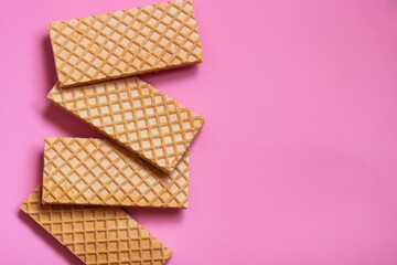 Waffles on a smooth pink background. perfect for illustrating a minimalist breakfast or dessert idea.