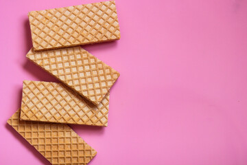 Waffles on a smooth pink background. perfect for illustrating a minimalist breakfast or dessert idea.
