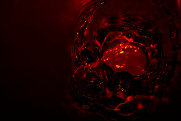 Metallic red water surface Soft waves and air bubbles in the water.