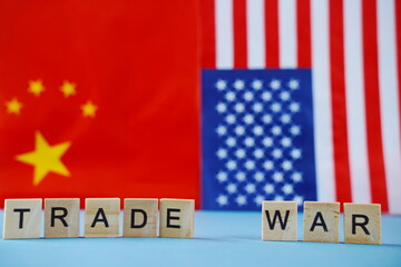 Fototapeta premium The flag of the USA and the flag of China. The inscription on their background: trade war.