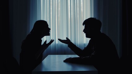 Silhouette of a Couple Arguing in Dimly Lit Room