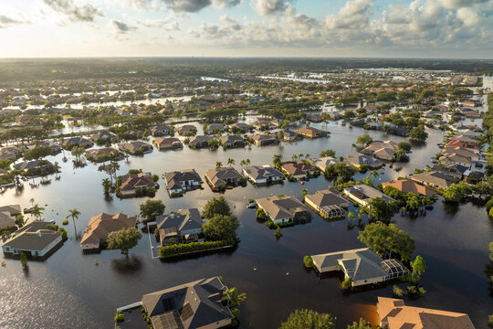 Flooded houses from hurricane rainfall water in Florida residential community. Aftermath of natural disaster in USA south