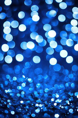 Abstract Blue Bokeh Background with Vibrant Circular Light Patterns and Textured Glitter Effect