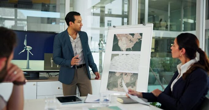 Meeting, map and business people with windmill in office for sustainability, innovation and renewable energy. Climate change, farm location and workers with wind turbine for electricity production