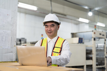 Male engineer, Industry factory, Storage warehouse. Senior Asian male plant engineer working with laptop computer at industry factor