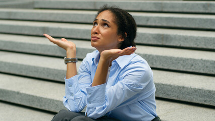 Depressed stressed African American businesswoman talking to God heaven upset business woman girl...