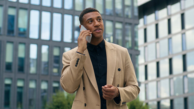 African American man guy male consulting client by call businessman business salesman entrepreneur employer talking mobile phone stand in city negotiation smartphone communicate conversation working