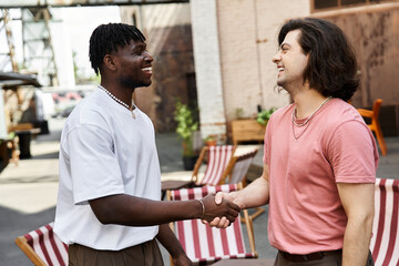 Joyful moments shared between two handsome men during a cozy cafe date filled with laughter