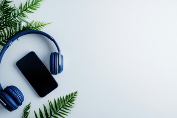 Smartphone and headphones with ferns on white