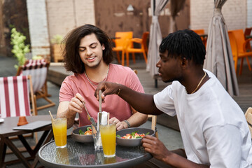 Romantic moments shared by a handsome gay couple during a delightful cafe date