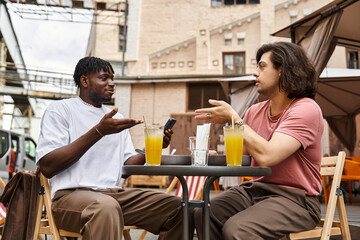 Enjoying a delightful afternoon conversation at a cozy cafe for a lovely gay couple