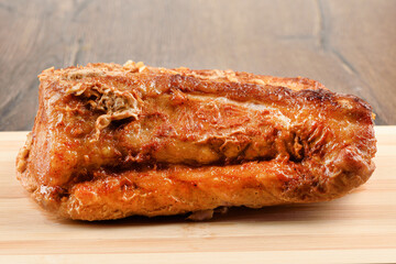 Close-up of oven-baked pork meat on a cutting board.