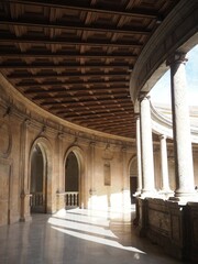 Generalife of Alhambra in Granada, Andalusia, Spain. Perspective of circular building: columns, sunlight and shadows. Historical architecture of the Renaissance.