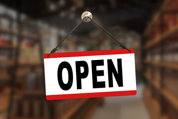 A monochromatic 'Open' sign, in bold black lettering against a pristine white background, gracefully dangles from the door of a charming street cafe.