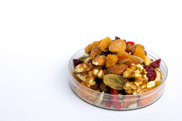 Dried fruit and nuts trail mix on white background