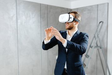 Young man wearing VR glasses, scrolling with hands in air using futuristic innovative technology...