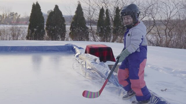 Young hockey player stepping onto the ice