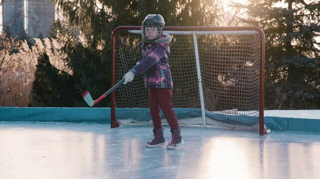 Slow motion hockey shot young girl on rink