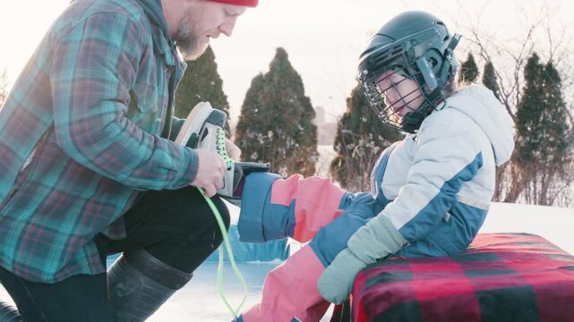 Daddy daughter lacing up some skates
