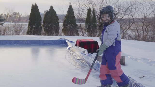 young girl stepping onto the ice