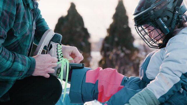 Lacing up skates for the game of hockey