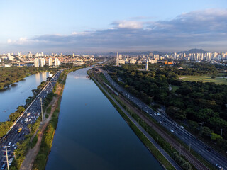 Rising sun on a river within the metropolis of São Paulo with the Pinheiros riverside.