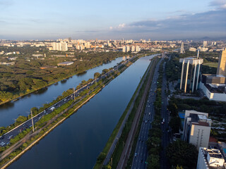 Rising sun on a river within the metropolis of São Paulo with the Pinheiros riverside.
