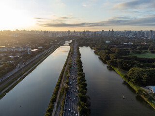 Rising sun on a river within the metropolis of São Paulo with the Pinheiros riverside.