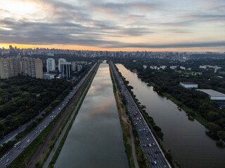 Rising sun on a river within the metropolis of São Paulo with the Pinheiros riverside.