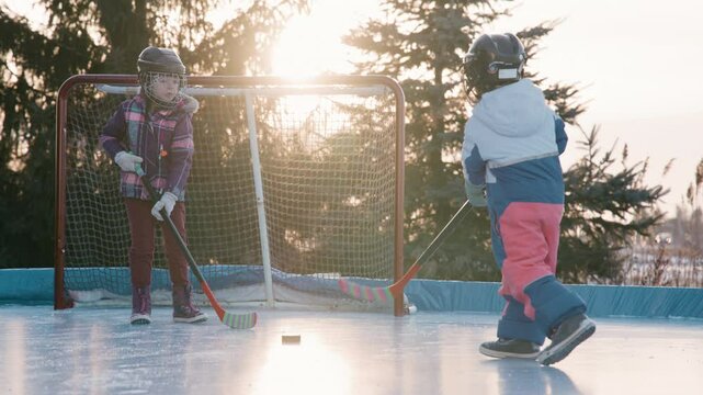 two sisters on the rink playing hockey