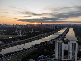 Rising sun on a river within the metropolis of São Paulo with the Pinheiros riverside.