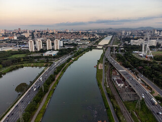 Rising sun on a river within the metropolis of São Paulo with the Pinheiros riverside.
