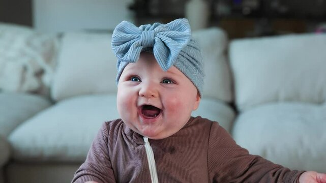 Adorable Cute Baby Girl with Blue Eyes Smiling and Laughing