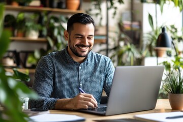 Positive Hispanic entrepreneur man using laptop for working in office, writing notes, smiling, talking on video call. Company manager, businessman watching professional learning webinar