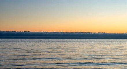 Fototapeta premium A misty dawn with soft, low-hanging clouds over a tranquil sea, AI Generated