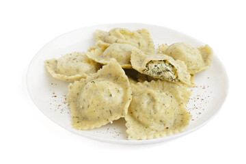 Plate of tasty ravioli with vegetables on white background