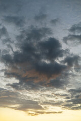 Bottom view of clouds against the sky during a yellow sunset