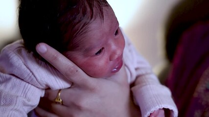 Mother gently holding her newborn baby girl, lovingly burping her after a nourishing breastfeeding session, cherishing their bond